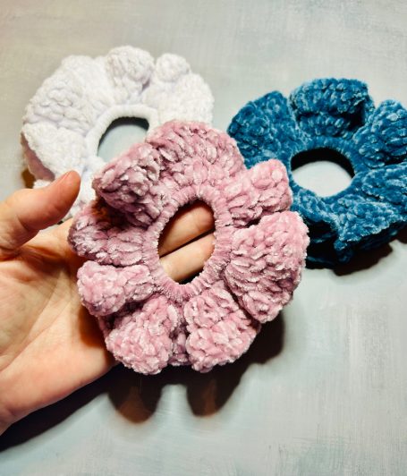 3 Velvet Crochet Scrunchie In a hand and on a desk